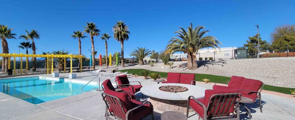 red patio furniture near an inground pool
